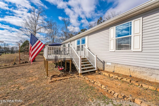 view of property exterior with stairs, crawl space, and a wooden deck