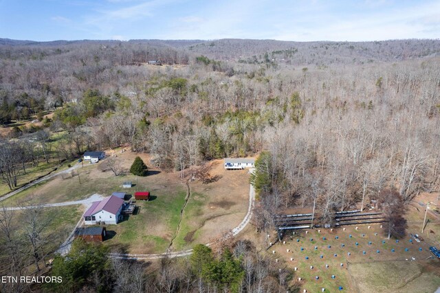 drone / aerial view featuring a forest view