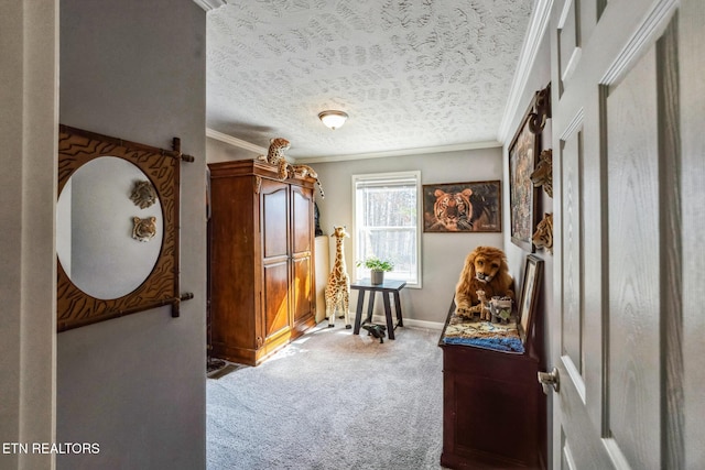 living area with ornamental molding, light colored carpet, a textured ceiling, and baseboards