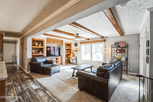 living area with a textured ceiling, ornamental molding, beamed ceiling, and baseboards