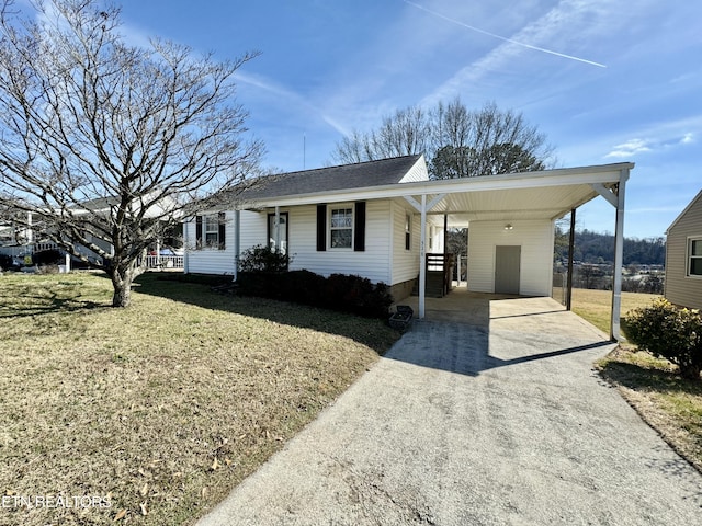 ranch-style house featuring a carport and a front lawn