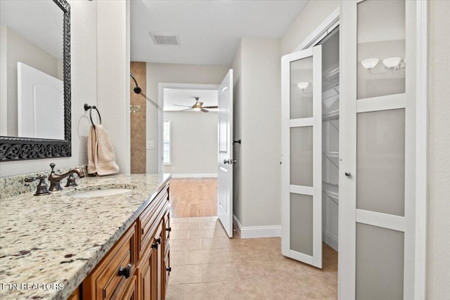 full bath featuring visible vents, ceiling fan, vanity, baseboards, and tile patterned floors