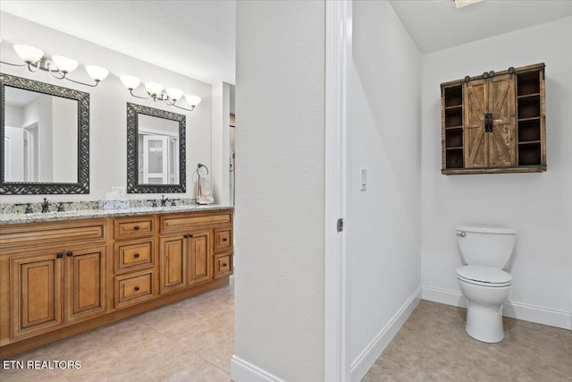 full bath with double vanity, toilet, a sink, tile patterned flooring, and baseboards