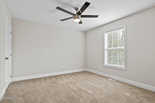 unfurnished room featuring ceiling fan, carpet, visible vents, and baseboards