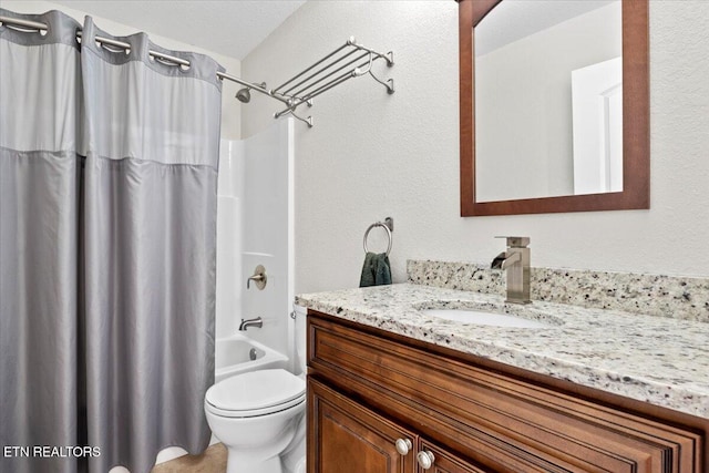 bathroom with toilet, shower / bath combination with curtain, and vanity