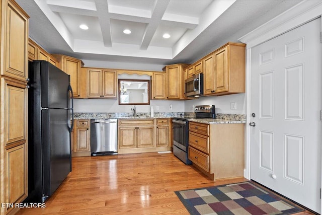 kitchen with light stone counters, beam ceiling, appliances with stainless steel finishes, light wood-type flooring, and coffered ceiling