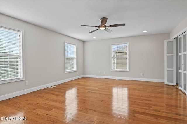 spare room featuring recessed lighting, visible vents, a ceiling fan, baseboards, and light wood-type flooring