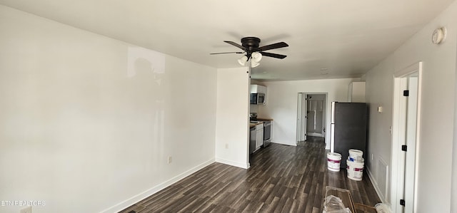 interior space featuring dark wood-type flooring, baseboards, and ceiling fan