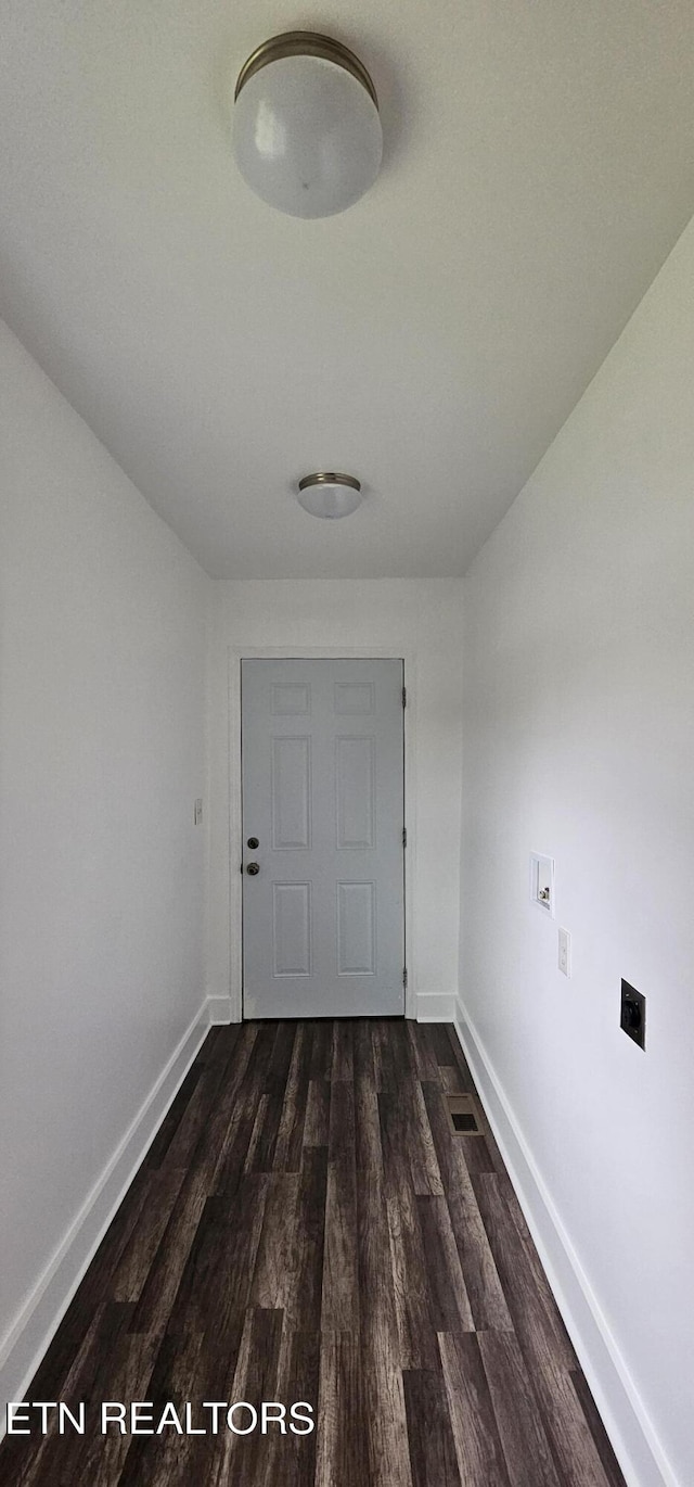 entryway featuring baseboards and dark wood-style flooring