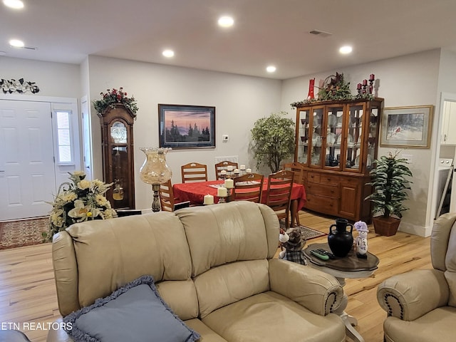 living area featuring light wood-style flooring, visible vents, and recessed lighting