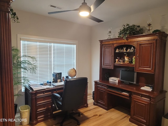 home office with a ceiling fan, visible vents, and light wood finished floors