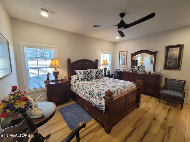 bedroom featuring light wood-style flooring, multiple windows, and visible vents