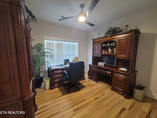 office space with light wood-type flooring and a ceiling fan