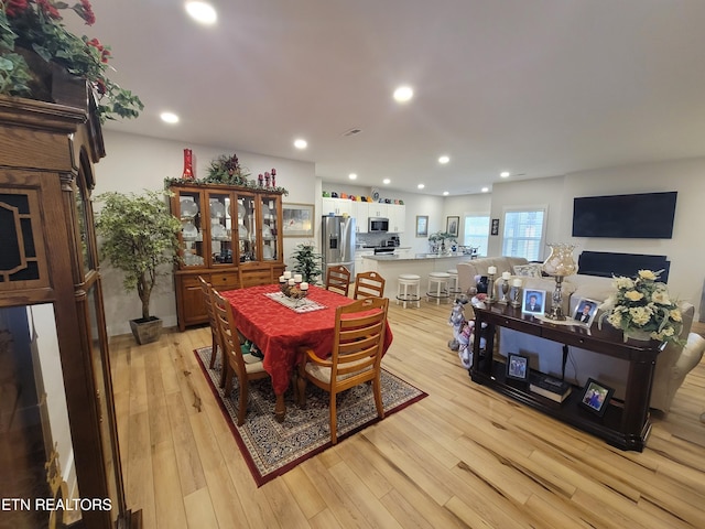 dining space with light wood-type flooring and recessed lighting