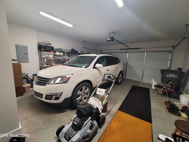 garage featuring electric panel and a garage door opener