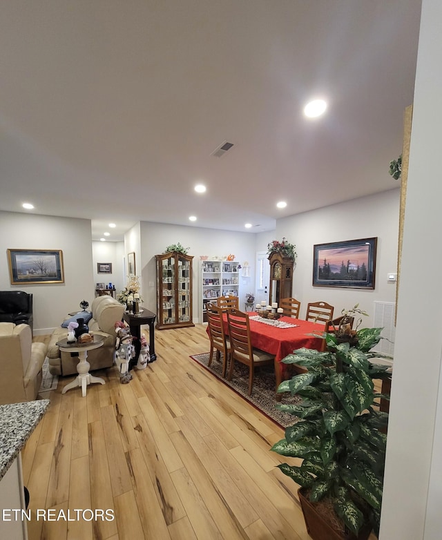 dining area with light wood-style floors, recessed lighting, and visible vents