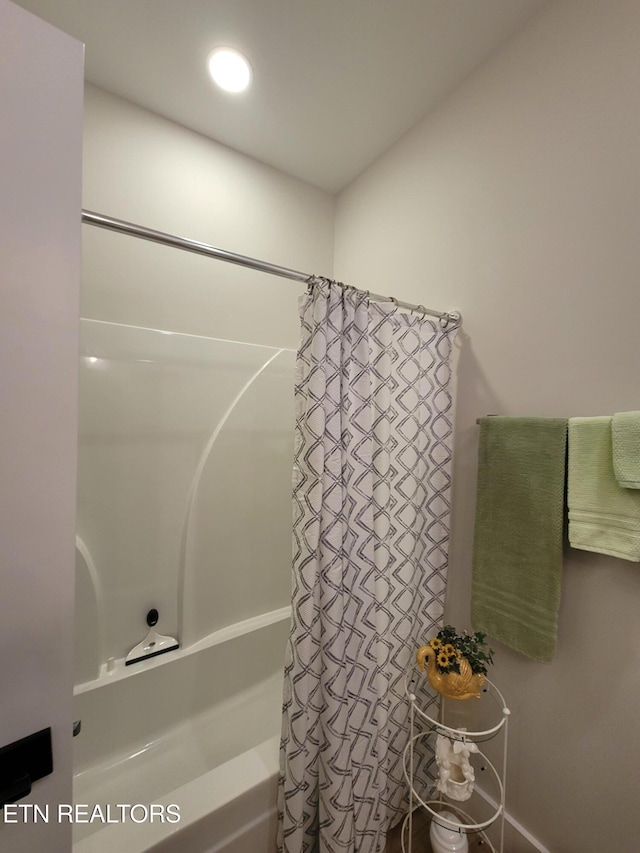 bathroom with shower / bathtub combination with curtain and recessed lighting