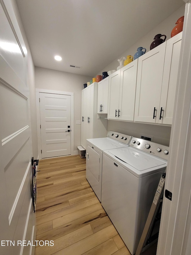 clothes washing area with recessed lighting, visible vents, washer and dryer, cabinet space, and light wood finished floors