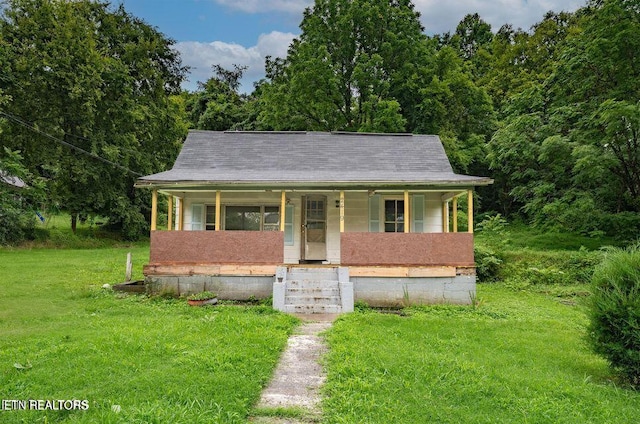 bungalow-style house with covered porch and a front yard