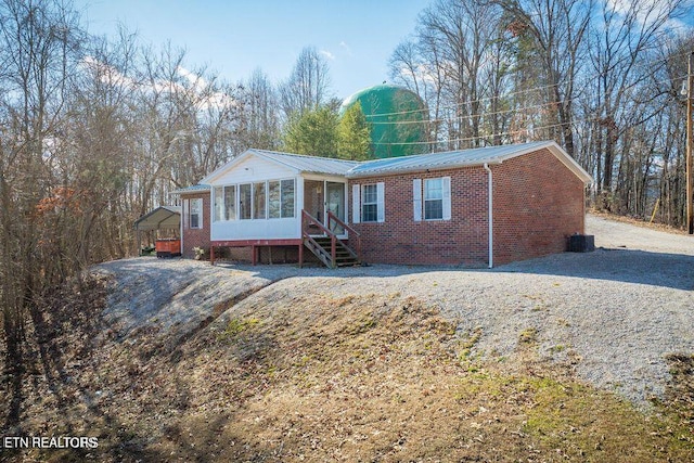 view of front of house featuring a carport and a sunroom