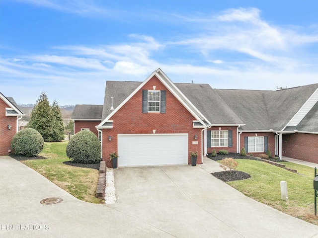 view of front of property with a front yard and a garage