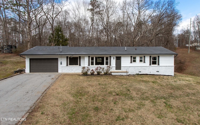 ranch-style home featuring a front lawn and a garage