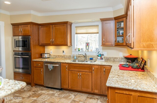 1017 Old Knoxville Hwy, Sevierville, TN 37862 - kitchen with appliances with stainless steel finishes, ornamental molding, sink, and light stone counters