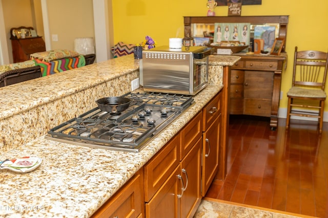 1017 Old Knoxville Hwy, Sevierville, TN 37862 - kitchen with light wood-type flooring, light stone countertops, and stainless steel gas stovetop