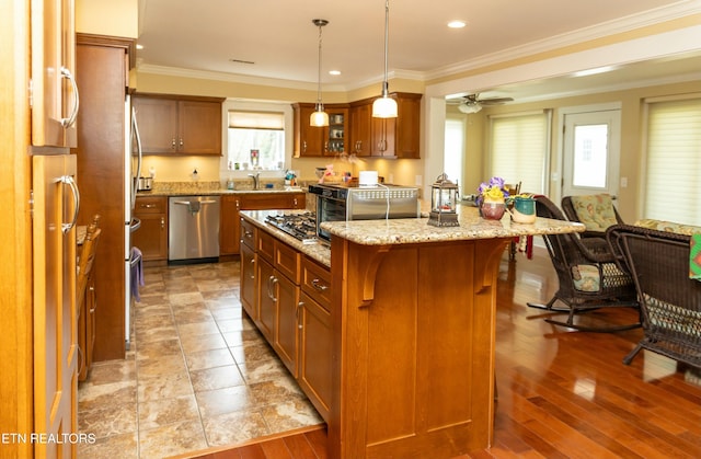 1017 Old Knoxville Hwy, Sevierville, TN 37862 - kitchen with a kitchen island, stainless steel dishwasher, light stone countertops, a breakfast bar area, and ornamental molding