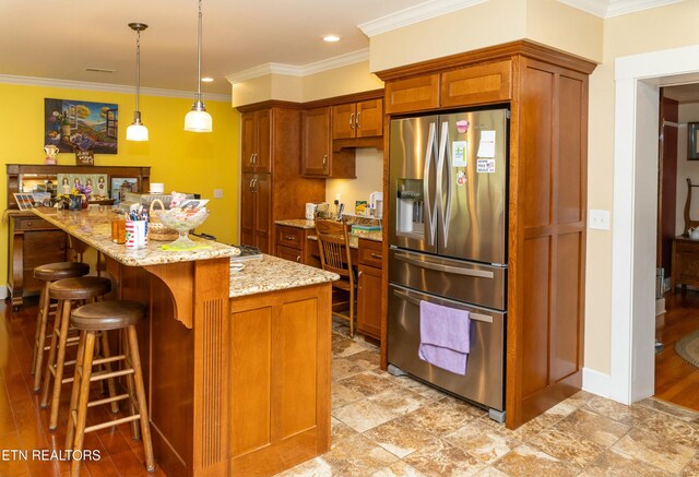 1017 Old Knoxville Hwy, Sevierville, TN 37862 - kitchen featuring decorative light fixtures, crown molding, light stone countertops, and stainless steel fridge with ice dispenser