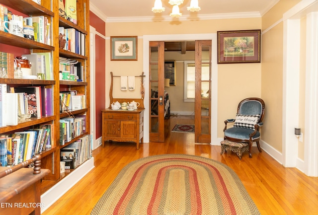 1017 Old Knoxville Hwy, Sevierville, TN 37862 - living area featuring light hardwood / wood-style flooring, a chandelier, and crown molding