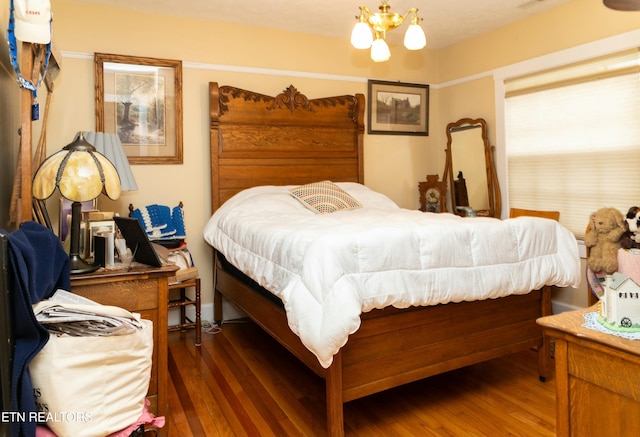 1017 Old Knoxville Hwy, Sevierville, TN 37862 - bedroom featuring a chandelier and dark wood-type flooring