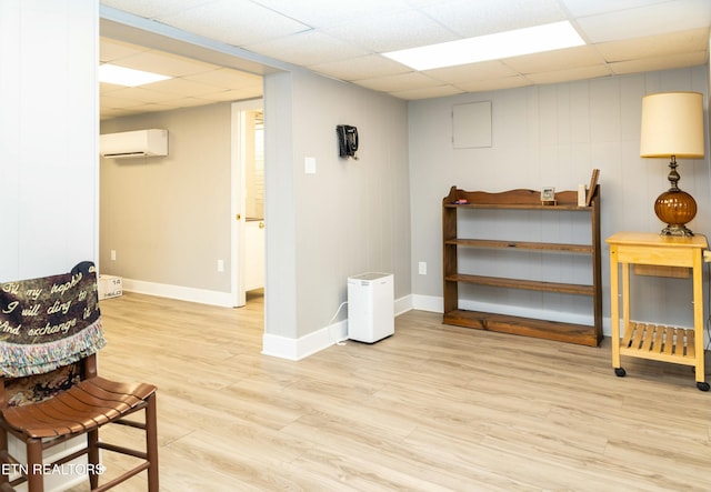 1017 Old Knoxville Hwy, Sevierville, TN 37862 - sitting room featuring a wall mounted AC, a paneled ceiling, and light hardwood / wood-style floors