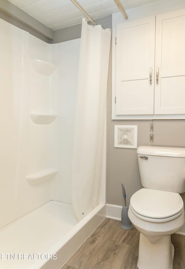 1017 Old Knoxville Hwy, Sevierville, TN 37862 - bathroom featuring toilet, hardwood / wood-style flooring, and a shower with curtain
