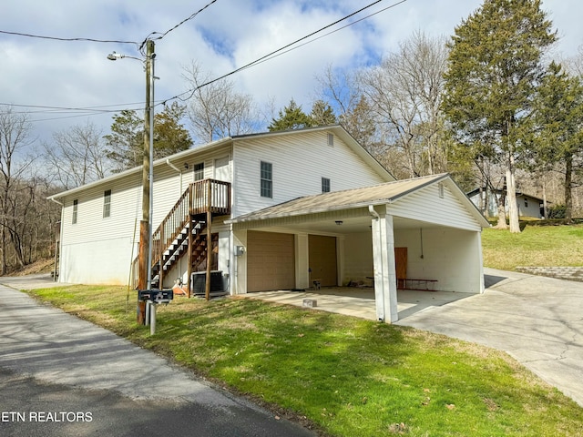 1017 Old Knoxville Hwy, Sevierville, TN 37862 - exterior space featuring central AC unit, a yard, a carport, and a garage