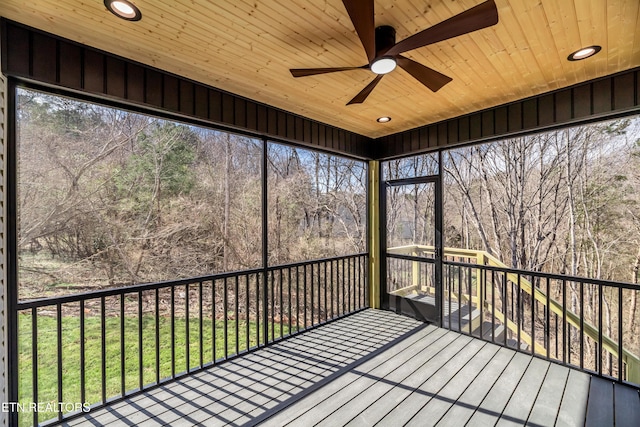 unfurnished sunroom featuring ceiling fan and wood ceiling