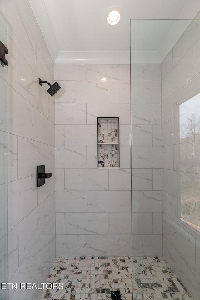 bathroom with a tile shower