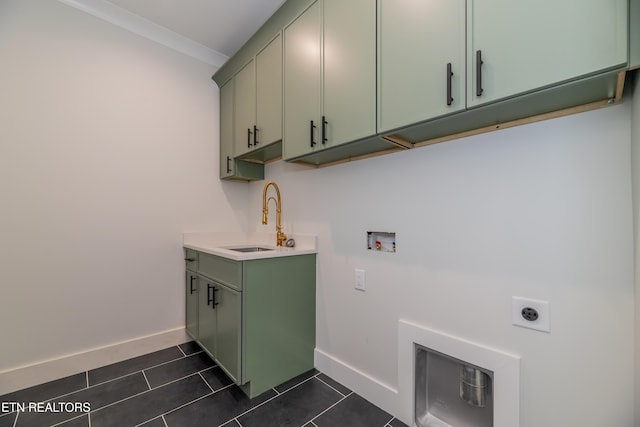 washroom featuring washer hookup, sink, cabinets, dark tile patterned floors, and hookup for an electric dryer