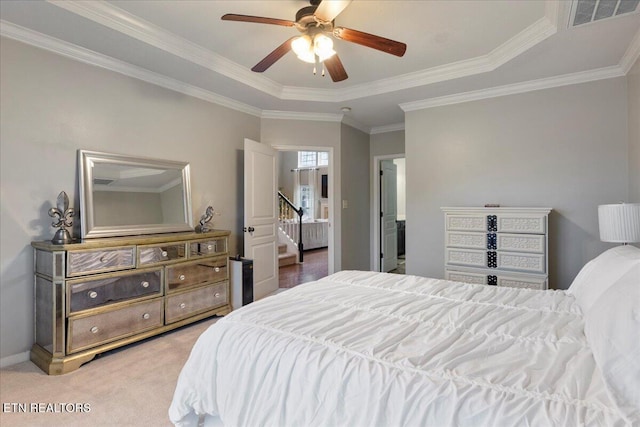 bedroom featuring ornamental molding, visible vents, baseboards, light carpet, and ceiling fan