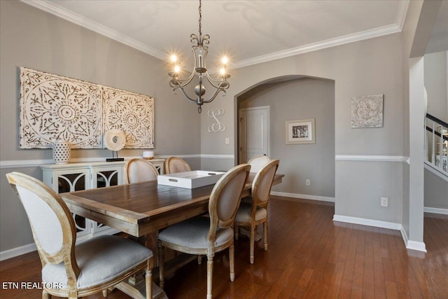 dining area with baseboards, crown molding, arched walkways, and dark wood-style flooring