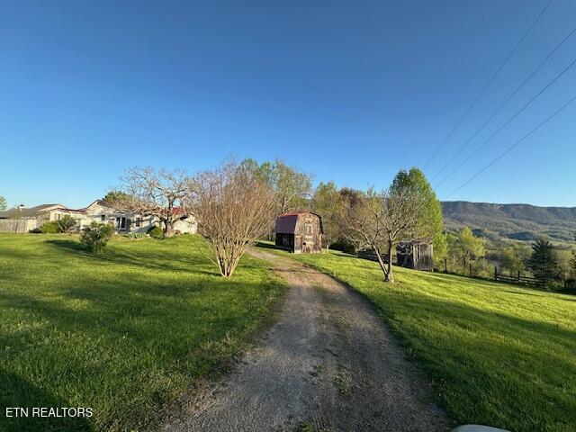 exterior space with an outdoor structure, a yard, and a shed