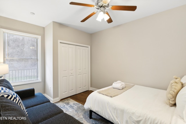 bedroom with ceiling fan, wood-type flooring, and a closet