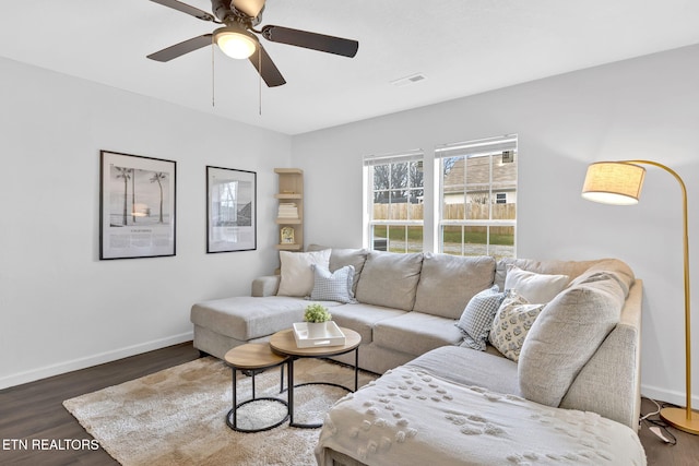 living room with ceiling fan and dark hardwood / wood-style flooring