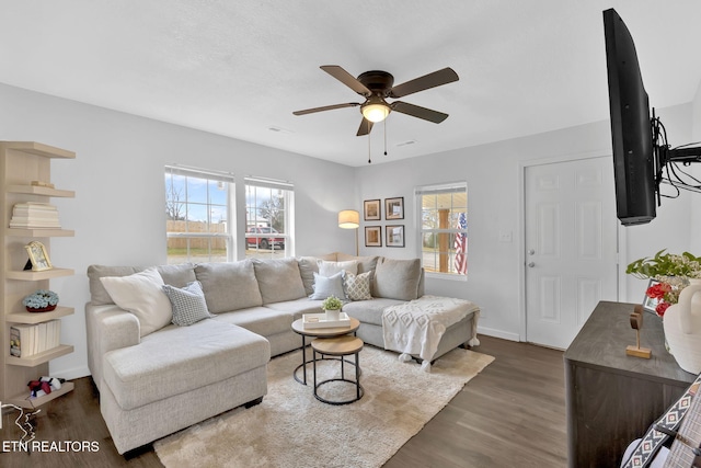 living room featuring dark hardwood / wood-style flooring, plenty of natural light, and ceiling fan