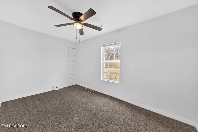 carpeted empty room with ceiling fan