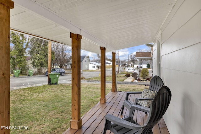 deck with covered porch and a yard