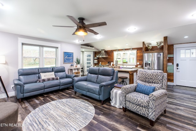 living area with ceiling fan, recessed lighting, wooden walls, vaulted ceiling, and dark wood finished floors