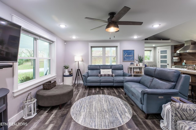 living room featuring recessed lighting, dark wood-style flooring, ceiling fan, and baseboards