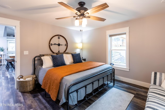 bedroom with dark wood-type flooring, baseboards, and a ceiling fan