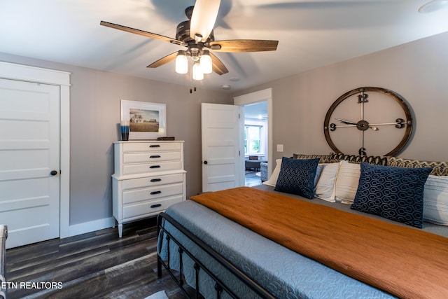 bedroom featuring ceiling fan, dark wood finished floors, and baseboards